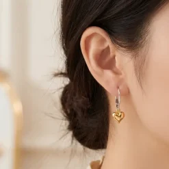 Model wears Gold Heart Charm Earring on sterling silver lever backs