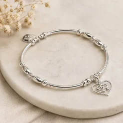 Infinity Heart Bracelet laying on a natural stone tray