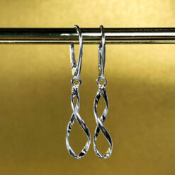 Silver Spiral Lever Back Earrings on a Gold background hanging From a gold bar.