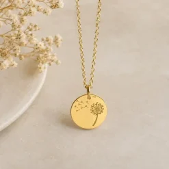 A Gold Dandelion Charm Pendant on a Gold rolo link chain