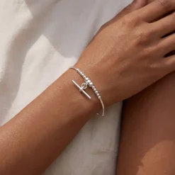 Sterling silver T bar charm bracelet worn on a models wrist